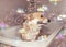 A cute Corgi dog in the bathroom washing in foam and soap bubbles smiling pretty