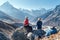 Cute Couple resting on the Everest Base Camp trekking route near Dughla 4620m. Man and woman enjoying a rest.They left Backpacks