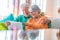 Cute couple of seniors watching movies having fun using laptop at home sitting on the sofa together. Two mature pensioners holding