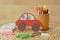 Cute crafty hand made red car for kids with colorful pastels and scissors