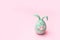 Cute creative photo easter bunny holding eggs on pink background with copy space