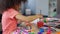 Cute curly African American girl putting paintbrush into water, leisure time