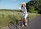 Cute Cyclist Girl Adjusting Hat