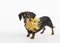 Cute dachshund with gold feathery collar on a white background