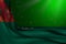 Cute dark image of Turkmenistan flag lying in corner on green background with bokeh and free place for text - any occasion flag 3d