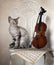 Cute devon rex cat and violin with bow on white vintage chair.