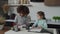 Cute diverse multiracial elementary age girls drawing pictures with colorful felt tip pens at home