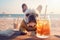 Cute dog with coctail relaxing on sandy beach near sea. Summer vacation with pet. Generative AI