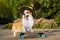 Cute dog puppy redhead  pembroke welsh corgi, dressed in a festive halloween black and yellow witch hat, standing  a skateboard on