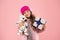 Cute dog toy quickly became her favourite friend. Happy child got toy gift pink background. Little girl cuddle soft toy