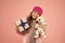 Cute dog toy quickly became her favourite friend. Happy child got toy gift pink background. Little girl cuddle soft toy