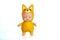 Cute doll in a fox costume with closed eyes. Stands on a white isolated background. Collection of toys. Soft focus.