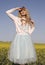 Cute doll look. White and blue romantic dress over blue sky.