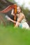 Cute Dreaming Harpist Woman in Light Dress Playing the Harp  In Park Outdoor