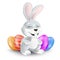 Cute Easter bunny sitting and laughing with decorated eggs. Vector illustration of squinting and smiling grey rabbit in 3d style