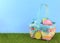 Cute Easter image with green grass and blue sky with colorful easter basket full of sparkly eggs.