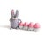Cute Easter knitted rabbit and pink eggs on white background. Easter composition
