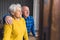 cute elder Caucasian couple looking out the window and smiling medium shot indoor seniority concept