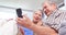 Cute elderly couple using smartphone