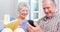 Cute elderly couple using smartphone