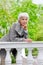 Cute elderly woman senior on the beautiful white verandah