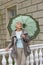 Cute elderly woman senior with an umbrella on the beautiful white verandah