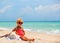 Cute elegant little girl on tropical beach