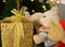 Cute elephant soft doll holding a big gold glitter square shaped gift box