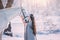 Cute elf princess in long gray cloak and vintage dress, girl with long black wavy curly hair stands next to white
