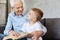 Cute energetic kid enjoying time with grandpa