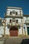 Cute facade of old house and awkward wooden door