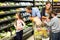 Cute family choosing groceries together