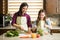 Cute family making a salad at home