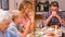 Cute family praying before eating dinner