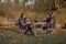 Cute family sitting on a picnic in a forest