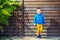 Cute fashionable boy in front of wooden wall