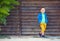 Cute fashionable boy in front of wooden wall