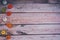 Cute felt gourds and pumpkins, left aligned on wooden background