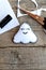 Cute felt Halloween ghost ornament, scissors, black thread, pieces and scraps of felt on old wooden background. Handcraft kit