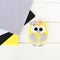 Cute felt owl toy. Grey, yellow, black, white felt. White background. Top view