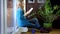 Cute female with book in hands read funny stories sitting on warm radiator.