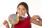 Cute female child holding big spiral lollipop candy and huge toothbrush in dental care concept