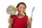 Cute female child holding big spiral lollipop candy and huge toothbrush in dental care concept