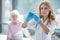 Cute female nurse holding an ampule with vaccine