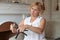 A cute fifty-year-old woman is sitting on an armchair