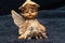 Cute figurine of a baby angel with wings and a silver pendant in the shape of a poodle dog