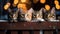 Cute fluffy cats peek out from the table in New Year\\\'s hats, festive garlands and bokeh on the image