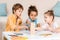 cute focused children building tower from wooden blocks