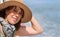 Cute forty year old woman with straw hat on the cruise ship