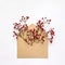 Cute fresh berries in an envelop on white background. Stylish flat lay. Minimal concept